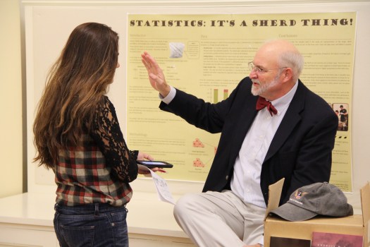 Dr. Emerson "Tad" Baker '76 discusses his research with a reporter from The Phillipian.