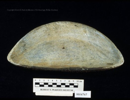 This stone blubber lamp was collected by William Duncan Strong in Hopedale, Labrador Canada. You can see charring along the edge as well as a hole in the center to hold the wick.
