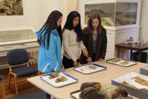 students looking a mukluks and wooden comb