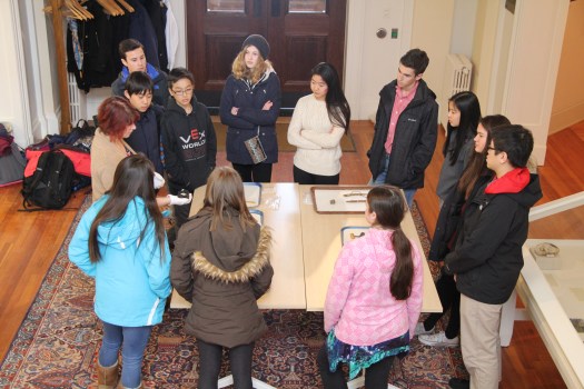 Lindsay Randall revealing to the entire class the names and uses of objects at one of the stations.