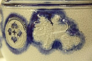 photo showing sprigged on detail of lion and rosette, Westerwald chamber pot