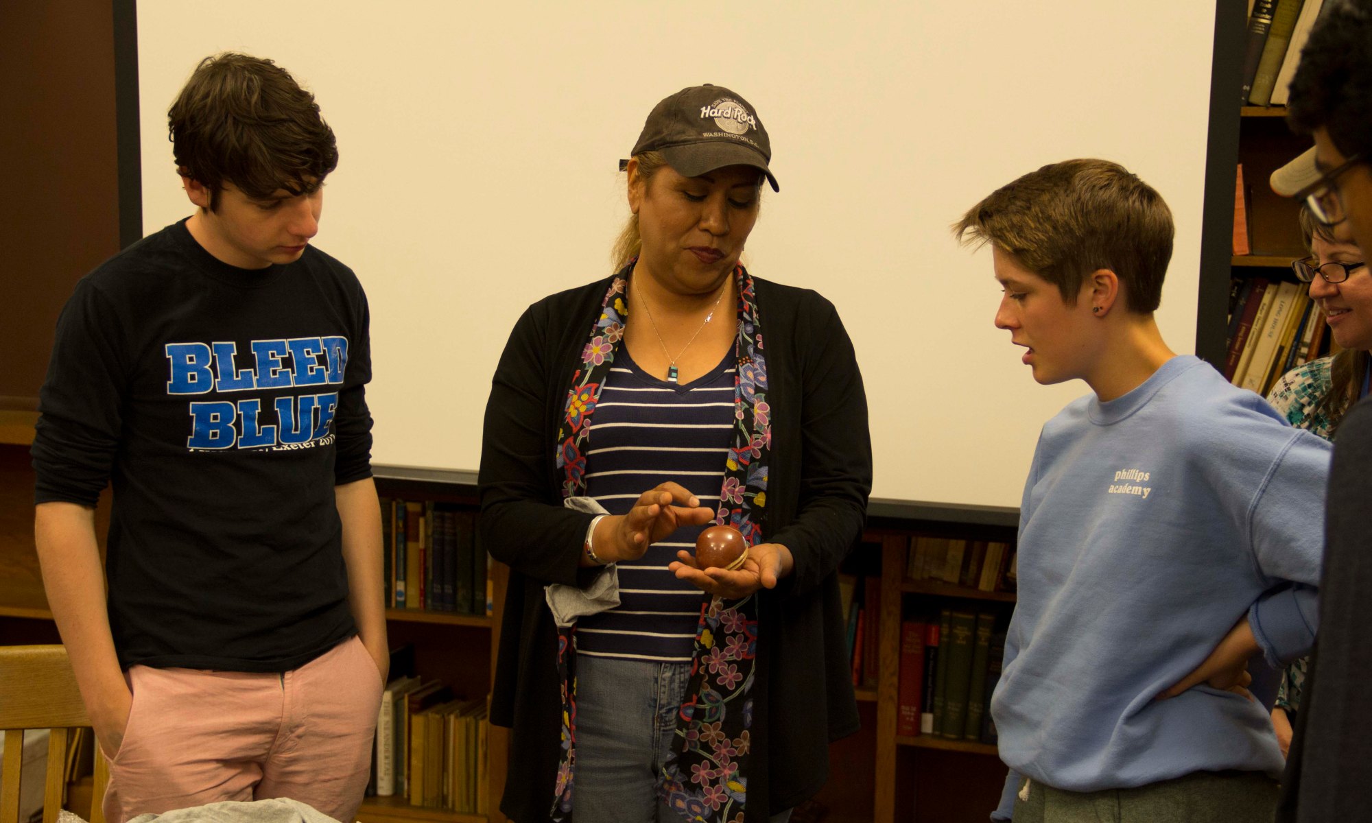 Alana and other work duty students learn about Pueblo pottery from Dominique Toya