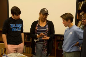 Alana and other work duty students learn about Pueblo pottery from Dominique Toya