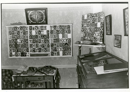 This black and white photograph depicts several cabinets in the home of Massachusetts native Roy Athearn, whose 13,000 object collection was significant.