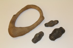 Image of a large stone belt and three zemis or three-pointed stones from Puerto Rico M. Eugene Verges Collections, Robert S. Peabody Institute of Archaeology.