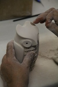 Image of Maxine Toya working on owl figurine.