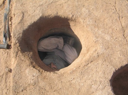 John inside a pit during excavations