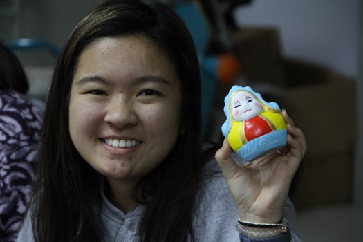 A student shows off her painted rabbit figurine.