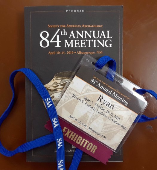 Image of name tag and program book from SAA conference.