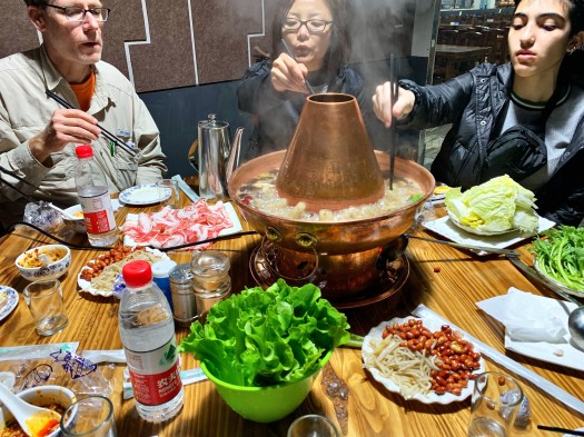 Image of students and chaperones sharing hot pot in Luoyang.