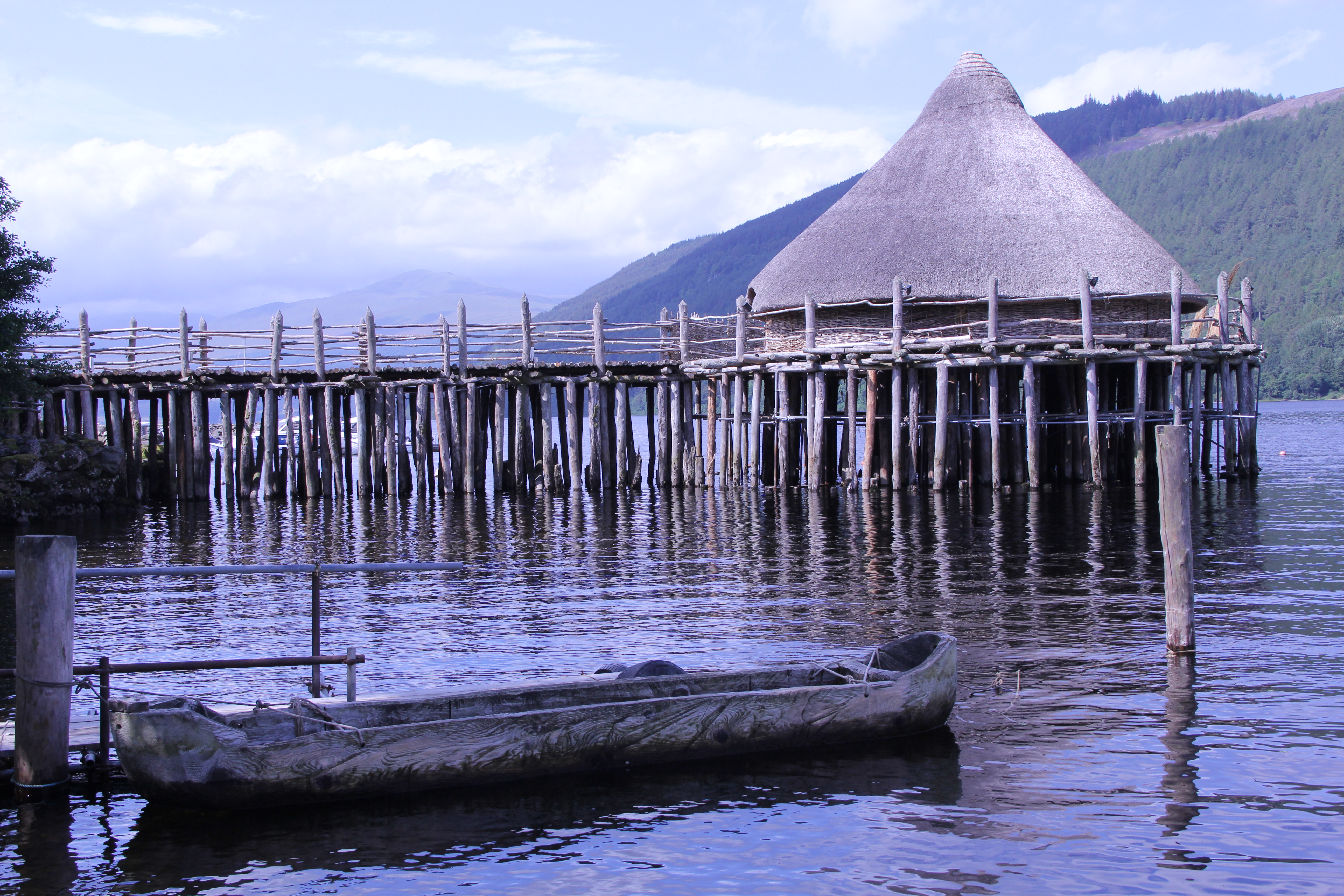 Image of thatched pile dwelling reconstruction at Scottish Crannog Centre.