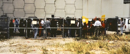A crowd of reporters outside the chain link fence at the Miami Circle site.