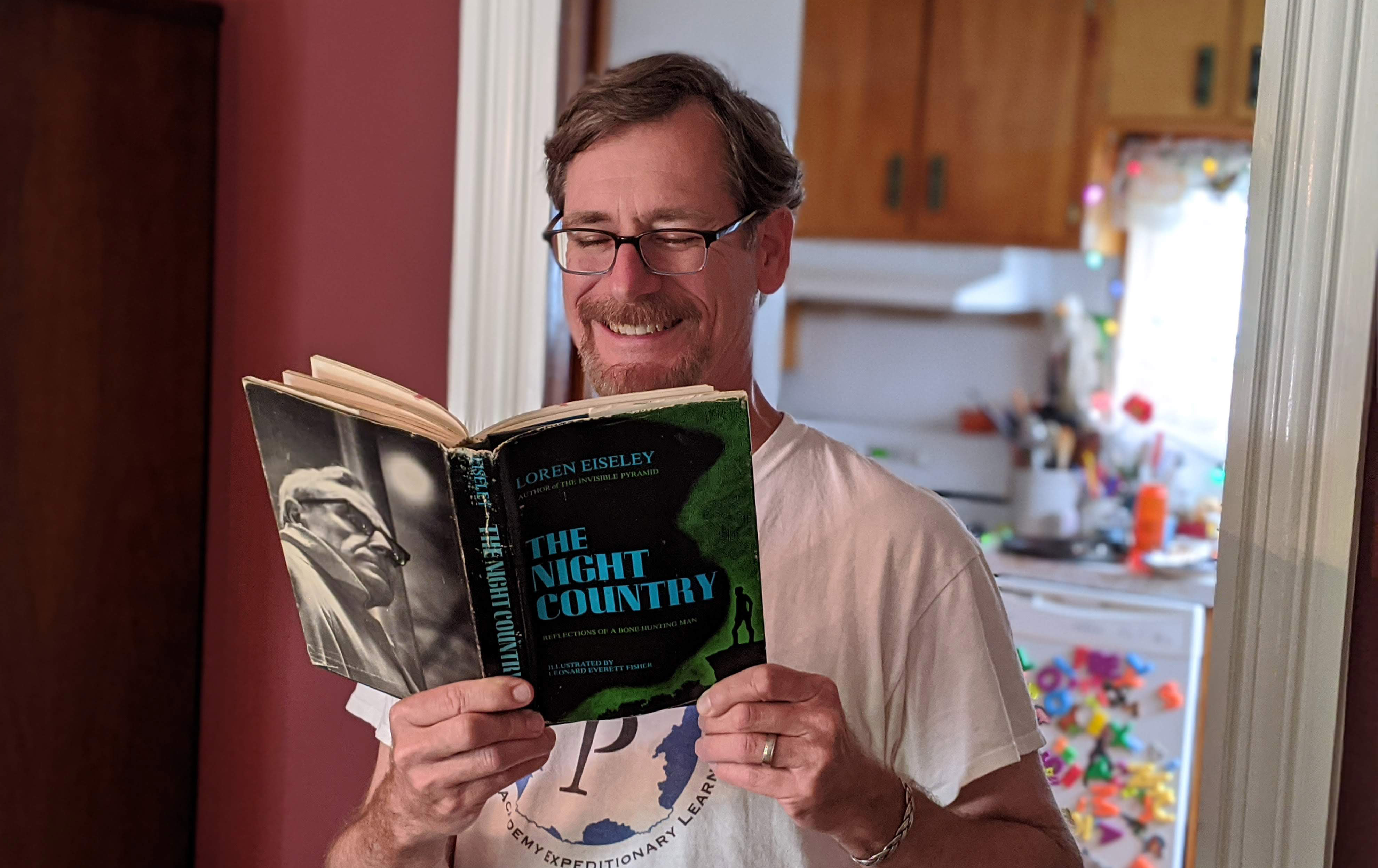 Ryan Wheeler reading his copy of Loren Eiseley's The Night Country.